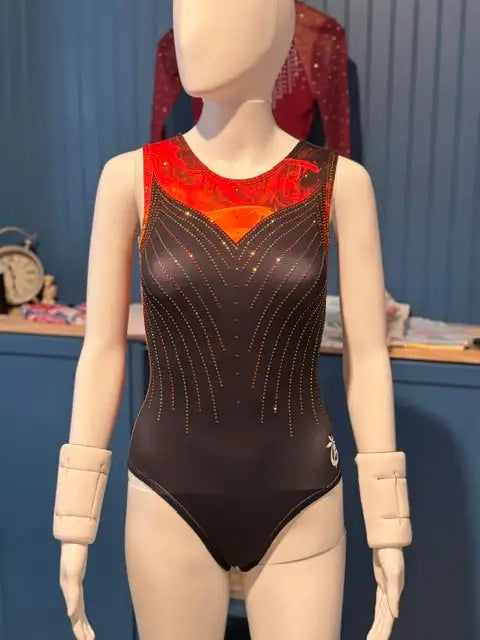 Black gymnastics leotard with a vibrant red and orange embellished neckline, featuring intricate gold beadwork along the front.