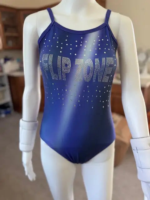 Blue gradient leotard with ’flip zone’ in rhinestones across the chest and scattered rhinestone dots.