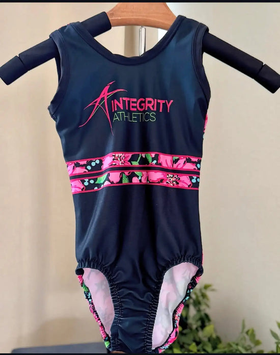 Navy blue sleeveless leotard with pink and green floral trim, featuring ’integrity athletics’ logo in matching colors